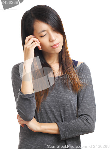 Image of young woman with headache holding head
