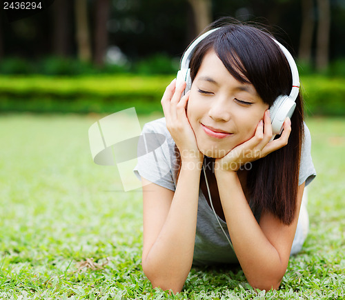 Image of Asian woman enjoy music