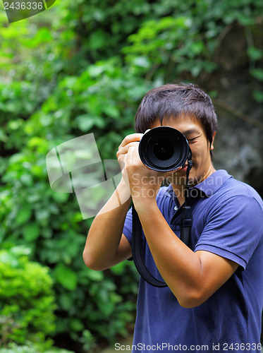 Image of Asian man taking photo