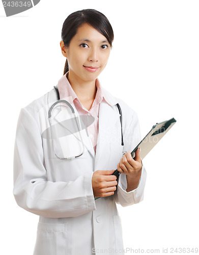 Image of young female doctor with patient file chart