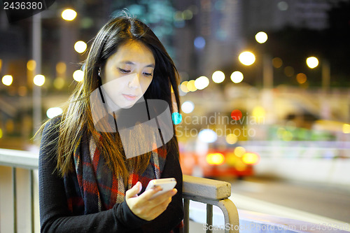 Image of woman using mobile at night 
