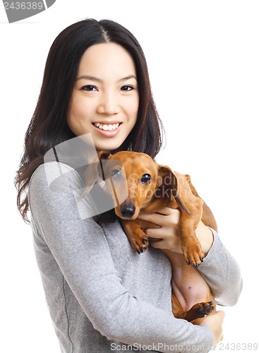Image of Asian woman with dachshund dog
