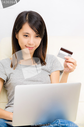 Image of Asian woman using laptop for online shopping