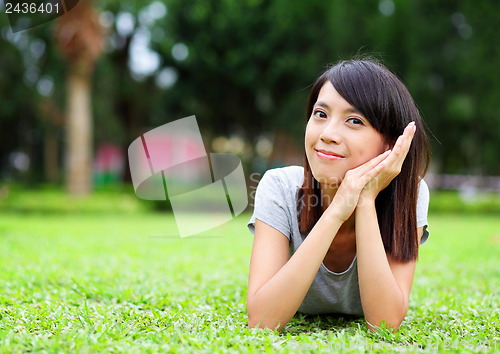 Image of Asian woman lying on the grass