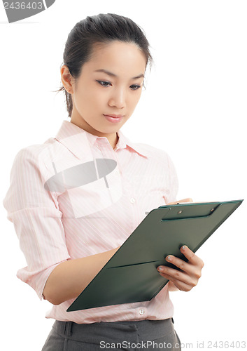 Image of Asian business woman write on file pad