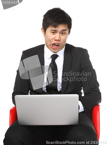 Image of Asian businessman shocked surprise by laptop computer