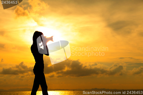 Image of Silhouette photographer at sunset