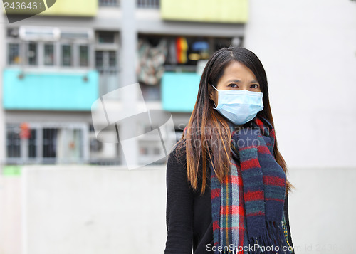 Image of woman wearing protective face mask on street