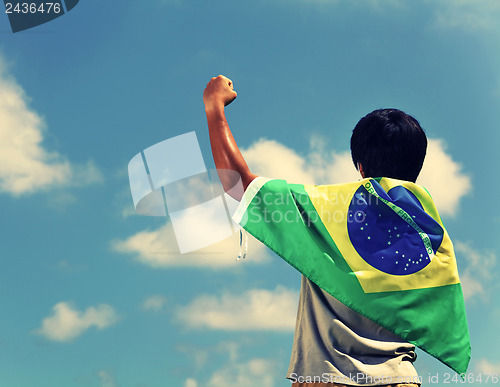 Image of Excited man holding a brazil flag