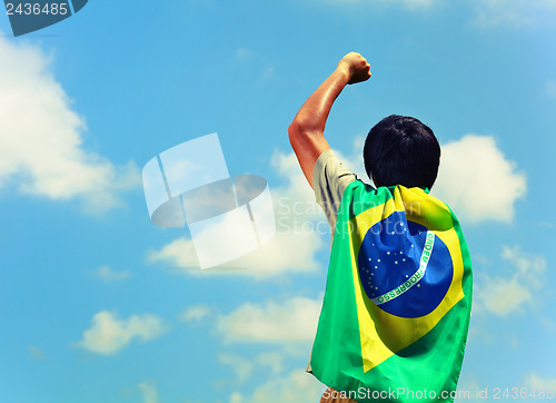 Image of Excited man holding a brazil flag