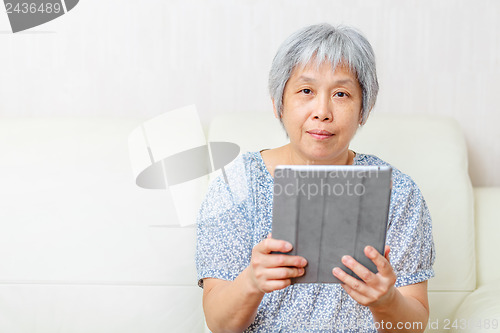 Image of Asian old woman with digital tablet