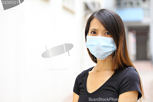 Image of woman wearing protective face mask on street