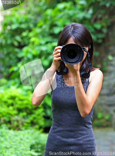 Image of Asian woman taking photo