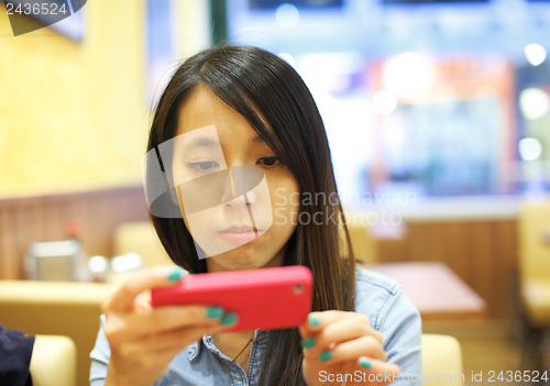 Image of Asian woman using mobile phone take photo in restaurant