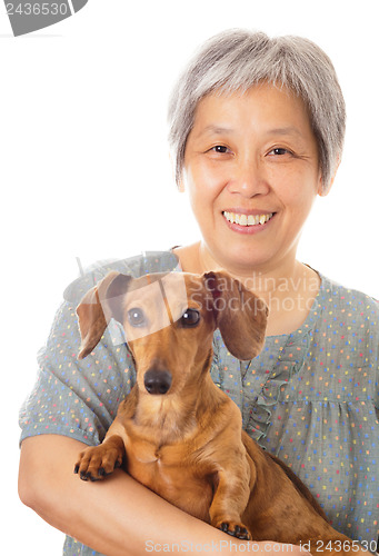 Image of Asian old woman and dachshund dog