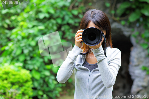 Image of Asian woman taking photo