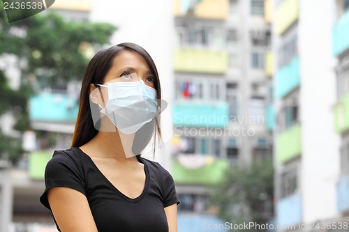 Image of Woman wearing medical face mask in crowded city