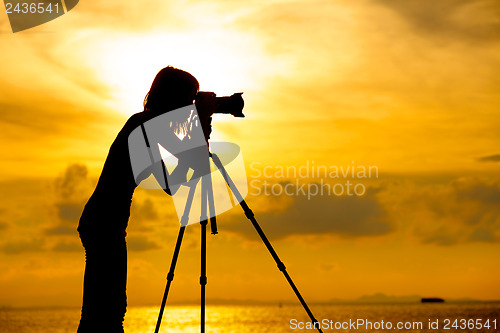 Image of Silhouette photographer at sunset