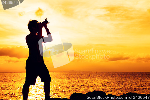 Image of Silhouette of photographer at sunset