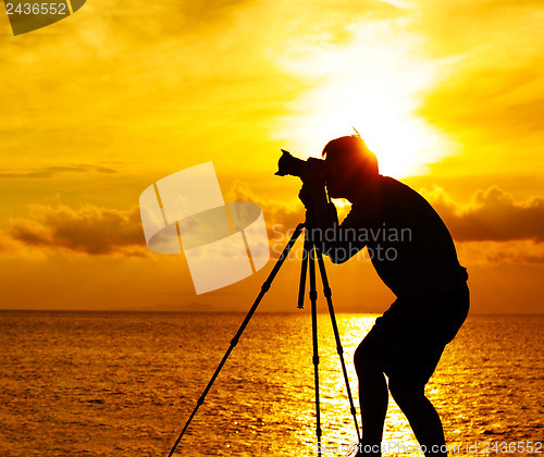 Image of Silhouette photographer at sunset