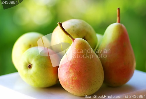 Image of Fresh ripe pears on green background