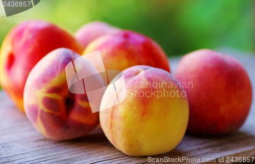 Image of  Ripe peaches on wooden table 