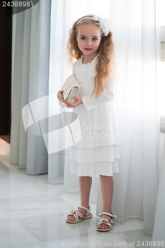 Image of Portrait of beautiful girl near white curtain