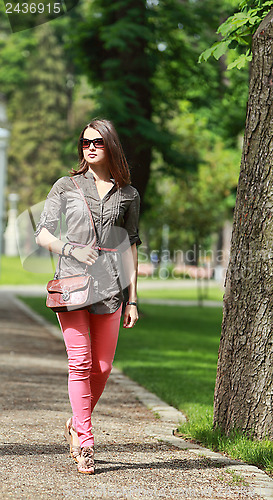 Image of Young Woman Walking in a Park