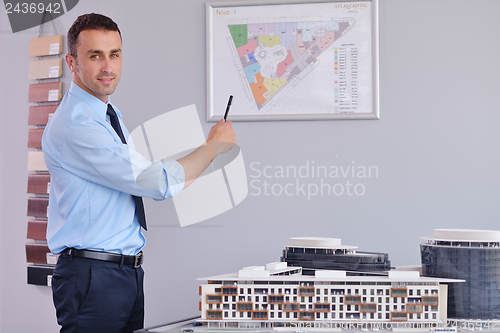 Image of happy young business man at office