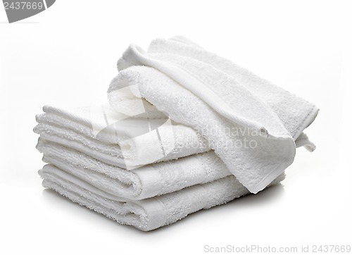 Image of Stack of white hotel towels on a white background