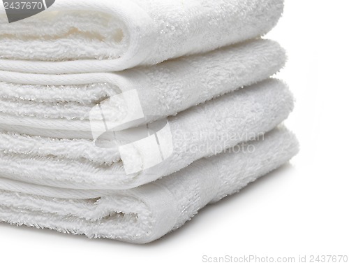 Image of Stack of white hotel towels on a white background