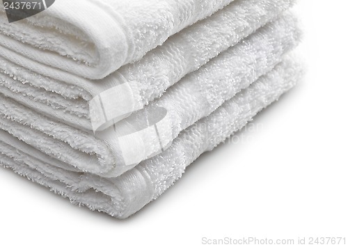 Image of Stack of white hotel towels on a white background