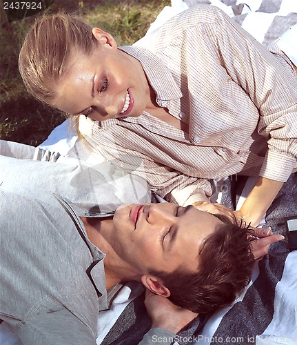 Image of beautiful young couple on grass