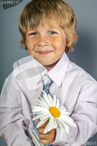 Image of handsome boy with flowers in hands
