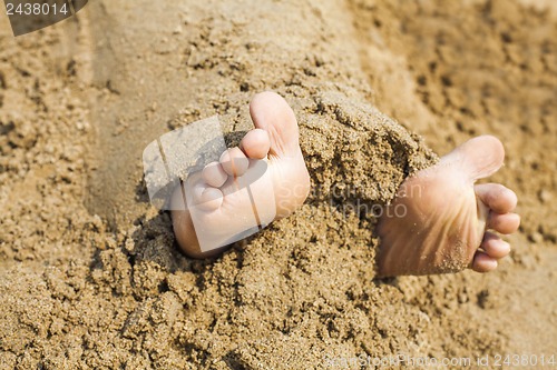 Image of Child's feet in the sand