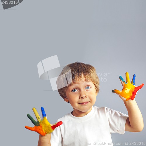 Image of boy with hands painted in colorful paints