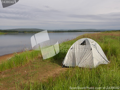 Image of Camping tent at the bank of a river