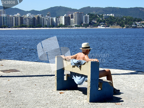 Image of Senior contemplating the sea sit on the bench