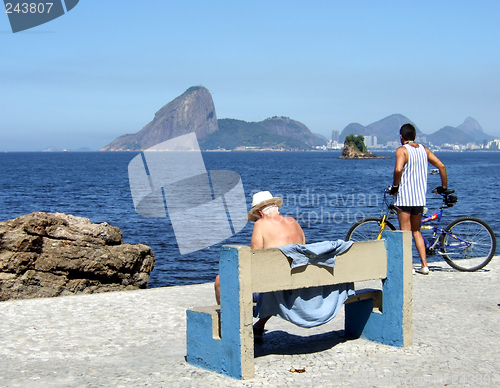 Image of Senior and man contemplating the sea with The Sugar loaf in the background