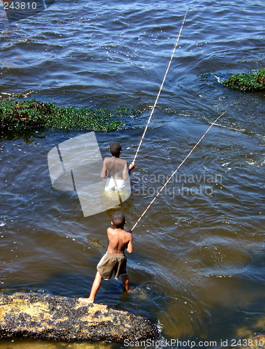 Image of Children fishing in the sea