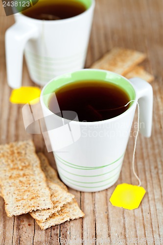 Image of two cups of tea and crackers