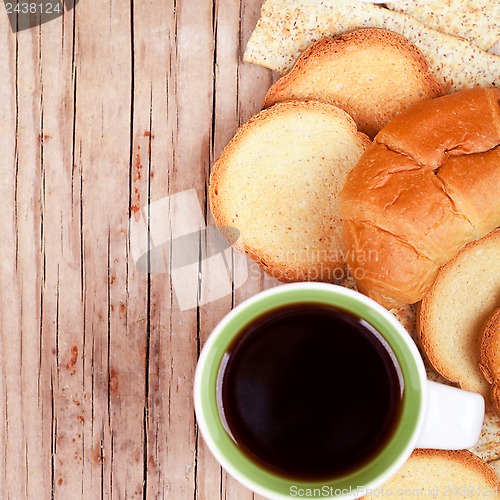 Image of cup of coffee, crackers and fresh croissant 