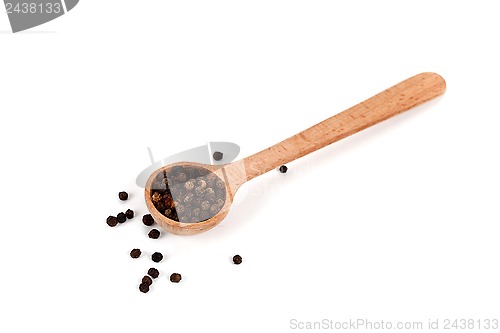 Image of black pepper in wooden spoon