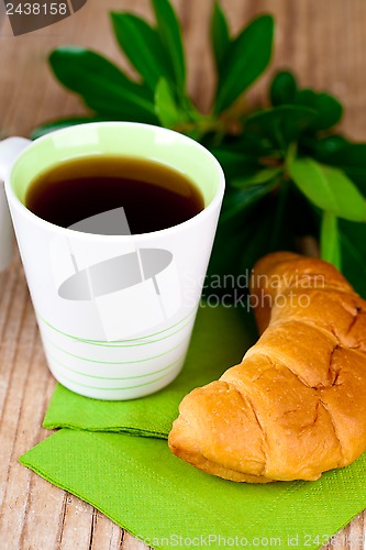 Image of cup of tea and fresh croissant 