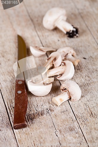Image of sliced champignons and old knife