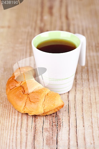 Image of cup of tea and fresh croissant 