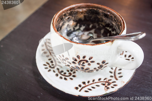 Image of Hot cappuccino cup  run out on wooden table