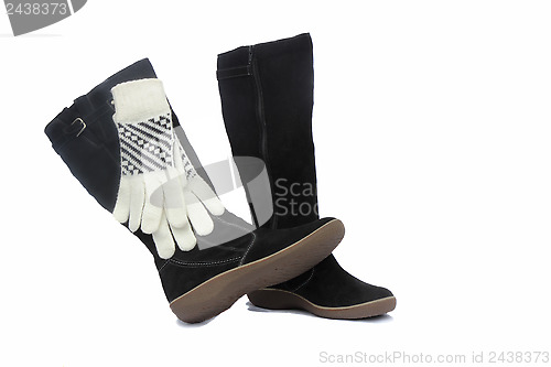 Image of Black womens winter boots and white gloves.