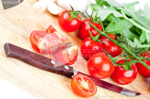 Image of fresh tomatoes, garlic and old knife