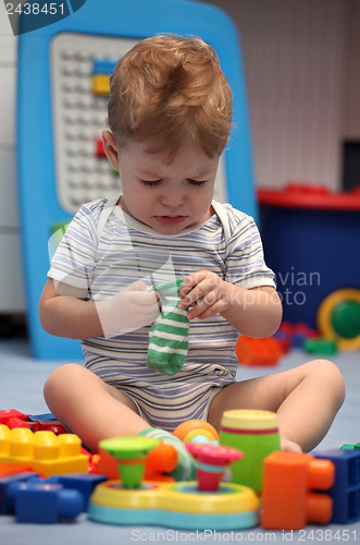Image of A baby boy crying in children's room